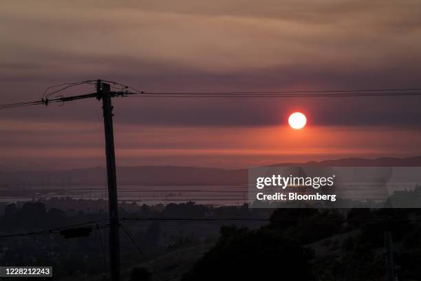 The sun is obscured by smoke from the LNU Lightning Complex fire in Vallejo, California, U.S., on Tuesday, Aug. 25, 2020. More than 7,000 blazes have...