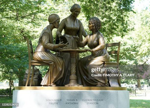 The unveiling of the statue of women's rights pioneers Susan B. Anthony, Elizabeth Cady Stanton and Sojourner Truth is seen in Central Park in New...