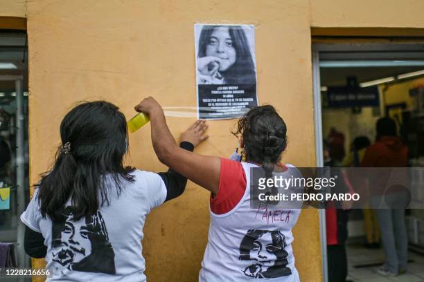 Relatives of missing teenager Pamela Cocina Rosales stick a missing person poster on a wall as part of her search, in Xochimilco, a municipality of...