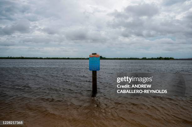 Sign is seen partially submerged after the water started to rise before the arrival of Hurricane Laura on a beach in Lake Charles, Louisiana on...