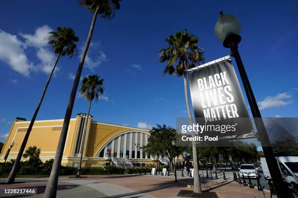 Black Lives Matter banner hangs outside of the arena after a postponed NBA basketball first round playoff game between the Milwaukee Bucks and the...