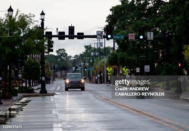 Car drives down an empty road before the arrival of Hurricane Laura in downtown Lake Charles, Louisiana on August 26, 2020. - Hurricane Laura is a...