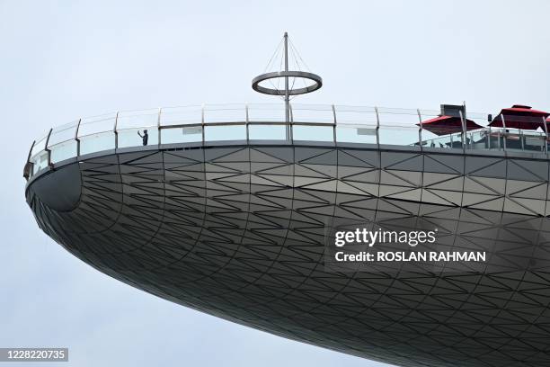 Man stands on the observation deck of Marina Bay Sands Skypark in Singapore on August 27, 2020.