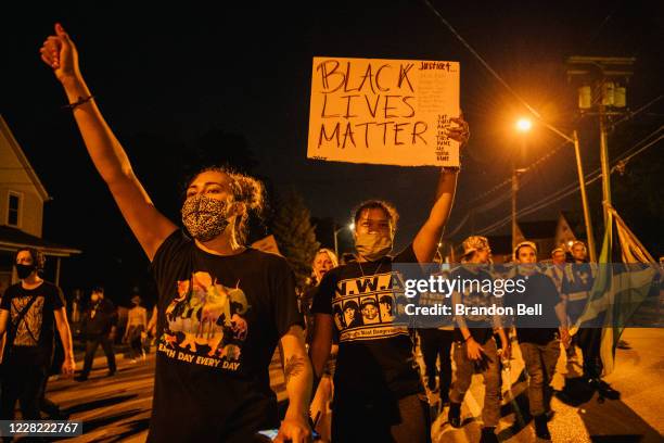 Demonstrators chant in a march on August 26, 2020 in Kenosha, Wisconsin. As the city declared a state of emergency curfew, a fourth night of civil...