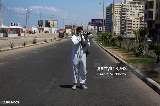 Photojournalist taking pictures during a lockdown imposed following the discovery of coronavirus cases in the Gaza Strip, Thursday, Aug. 27, 2020. On...