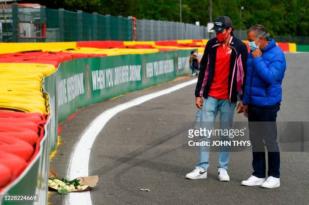 French driver Giuliano Alesi and his father, French former racing driver Jean Alesi place a bouquet of flowers at the site where late French racing...