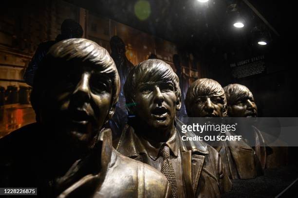 Busts of the members of British rock band The Beatles are displayed in the Cavern Club as it reopens to the public with live music to host their...