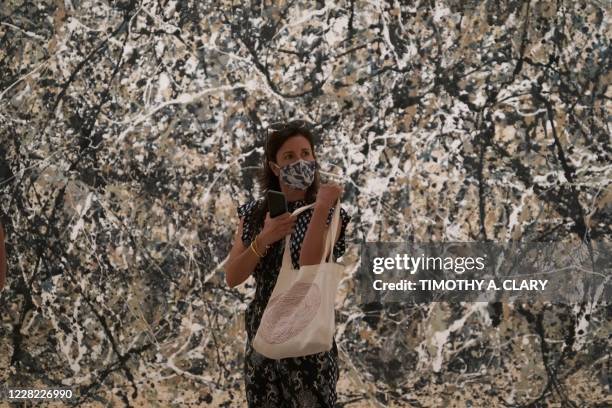 Woman looks at Jackson Pollock's "Autumn Rhythm Number 30 " as the Museum of Modern Art reopens its doors to the public on August 27, 2020 in New...