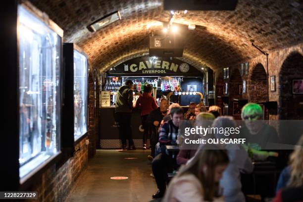 Customers are seen inside The Cavern Club reopens to the public with live music to host their annual 'Beatleweek' celebration of music by The Beatles...
