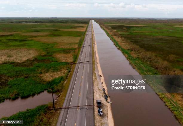 This aerial view shows power lines downed by Hurricane Laura across Highway 27 on August 27, 2020 in Creole, Louisiana. - Hurricane Laura slammed...
