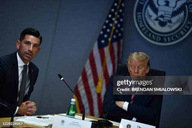 Acting Homeland Security Security Secretary Chad Wolf speaks as US President Donald Trump listens during a briefing for Hurricane Laura on August 27,...