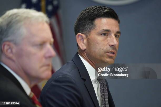 Chad Wolf, acting secretary of the Department of Homeland Security , speaks while Mark Meadows, White House chief of staff, left, listens during a...