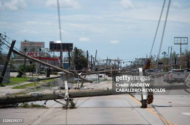 Downed power lines block a major road following the passing of hurricane Laura in Lake Charles, Louisiana, on August 27, 2020. - Hurricane Laura tore...