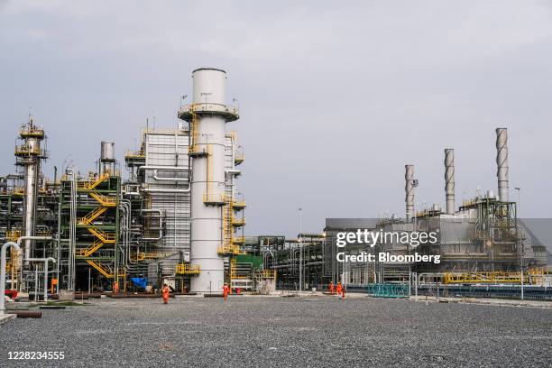 Stack towers at the under-construction Dangote Industries Ltd. Oil refinery and fertilizer plant site in the Ibeju Lekki district, outside of Lagos,...