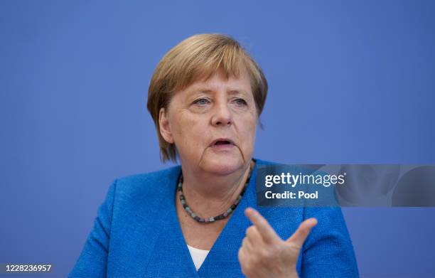 German Chancellor Angela Merkel gestures as she speaks to the media at her annual summer press conference during the coronavirus pandemic on August...