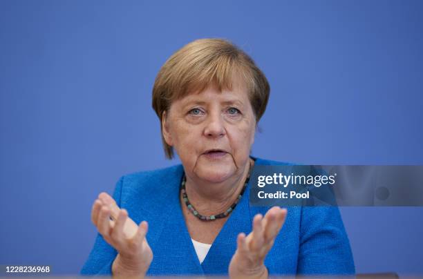 German Chancellor Angela Merkel gestures as she speaks to the media at her annual summer press conference during the coronavirus pandemic on August...