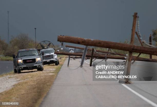 People trying to reach their homes in Cameron parish drive past downed power lines after the passing of Hurricane Laura south of Lake Charles,...