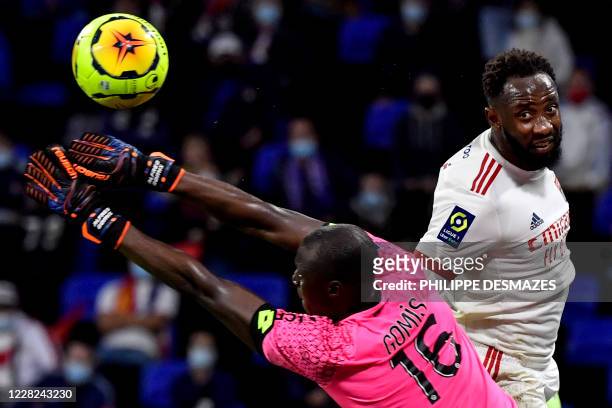 Dijon's Senegalese goalkeeper Alfred Gomis stops the ball in front of Lyon's French forward Moussa Dembele during the French L1 footall match between...