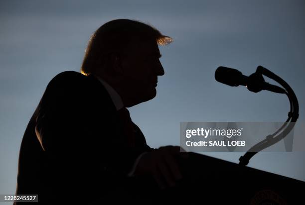 President Donald Trump addresses supporters during a campaign rally at Manchester - Boston Regional Airport in Londonderry, New Hampshire, August 28,...