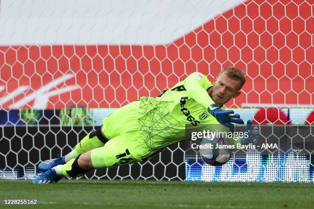 Adam Davies of Stoke City saves a penalty during the penalty shoot out during the Carabao Cup First Round match between Stoke City v Blackpool at...