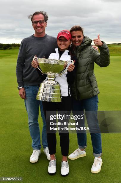 Aline Krauter of Germany poses with the trophy and her parents Karina and Rolf following her victory during the Final on Day Five of The Women's...