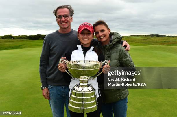 Aline Krauter of Germany poses with the trophy and her parents Karina and Rolf following her victory during the Final on Day Five of The Women's...