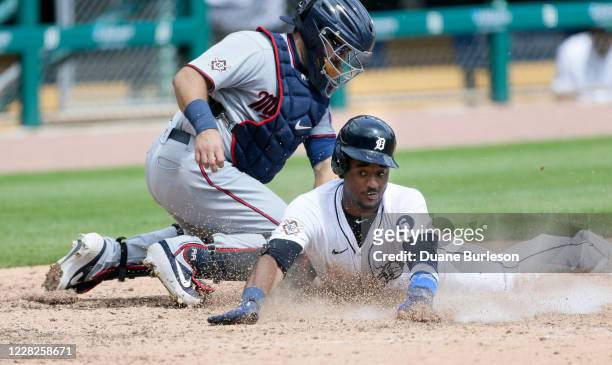 IDETROIT, MI Niko Goodrum of the Detroit Tigers is tagged by catcher Alex Avila of the Minnesota Twins at home plate during the fifth inning of game...