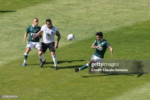 Esteban Paredes of Colo-Colo fights for the ball with Victor Retamal of Santiago Wanderers during a match been Colo-Colo and Santiago Wanderers as...