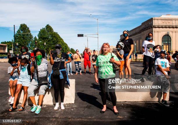 Demonstrators look on as speakers talk about the shooting of Jacob Blake during a rally against racism and police brutality in Kenosha, Wisconsin, on...