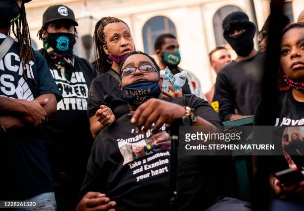 Jacob Blake Sr. And Zanetia Blake, father and sister of Jacob Blake, sit together on a bench during a rally against racism and police brutality in...