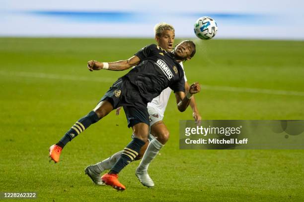 Jose Andres Martinez of Philadelphia Union competes for the ball against Yamil Asad of D.C. United in the first half at Subaru Park on August 29,...
