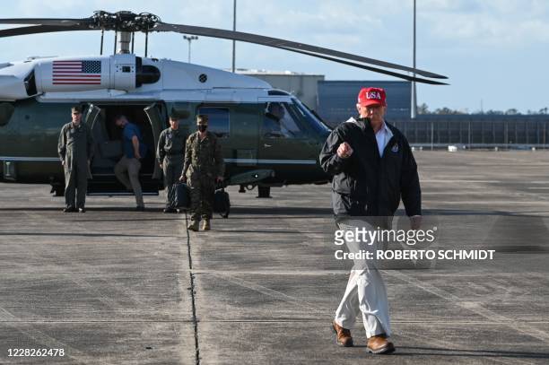 President Donald Trump gestures as he walks on the tarmac of Chennault International Airport in Lake Charles, Louisiana, to board Air Force One and...