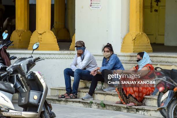 People wait to get tested for the Covid-19 coronavirus outside a testing facility in Allahabad on August 30, 2020. - India on August 30 set a...