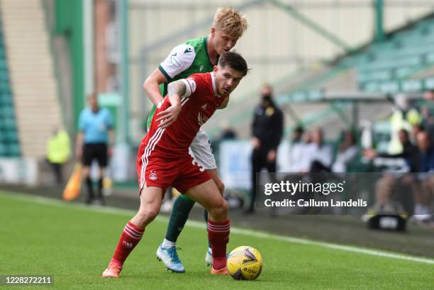 Josh Doig of Hibernian FC and Matthew Kennedy of Aberdeen FC tussle it out during the Scottish Premier League match between Hibernian FC and Aberdeen...