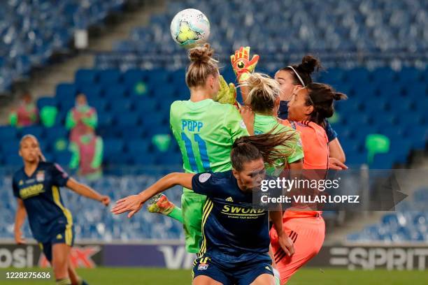 Lyon's French goalkeeper Sarah Bouhaddi collides with VfL Wolfsburg's Swedish midfielder Fridolina Rolfo during the UEFA Women's Champions League...