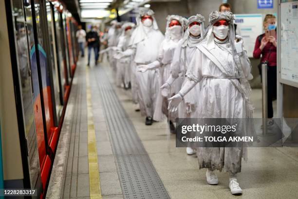 Activists from the Climate protest group Extinction Rebellion parade along the DLR platform at Woolwich Arsenal in south east London on August 31 to...