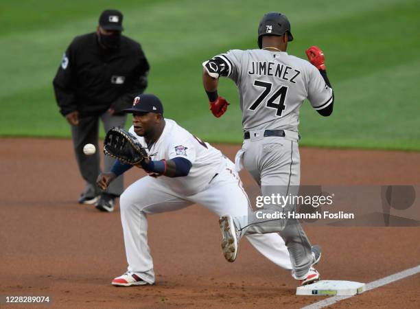 Eloy Jimenez of the Chicago White Sox is out at first base as Miguel Sano of the Minnesota Twins catches the ball during the first inning of the game...