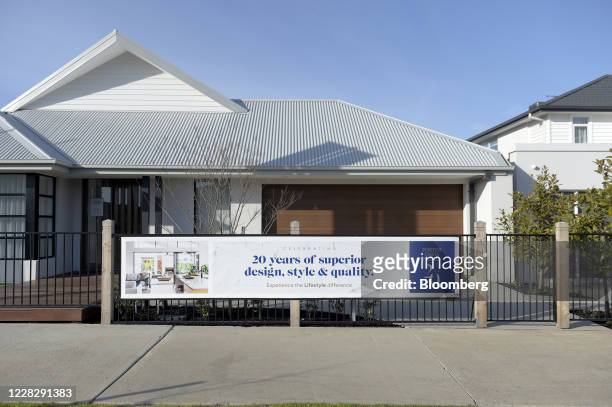 An advertisment for residential property is displayed on the fence of a show home at a new housing development in Melbourne, Australia, on Tuesday,...