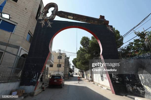 Entrance gate and a gigantic key that represents the hope of returning back to their land and homes, is seen on top of it as the Palestinians evicted...