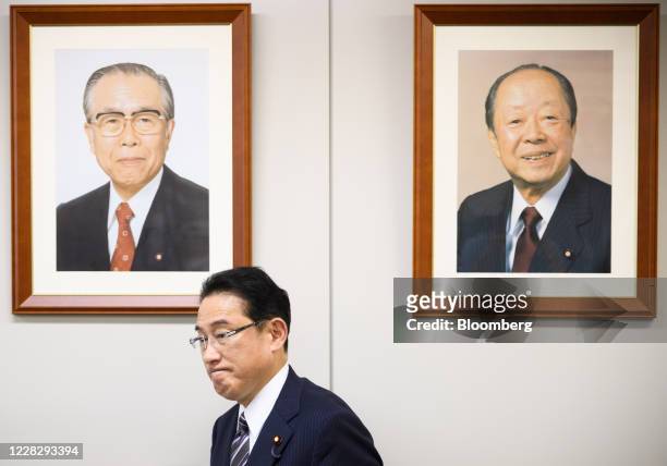 Fumio Kishida, chairman of the Policy Research Council at the Liberal Democratic Party , stands in front of a photograph of Mitsuo Horiuchi, former...