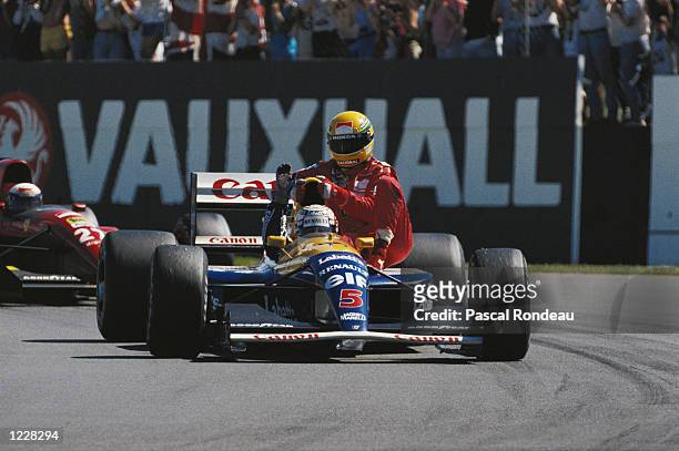 Williams Renault driver Nigel Mansell of Great Britain gives McLaren Honda driver Ayrton Senna of Brazil a lift home after the British Grand Prix at...