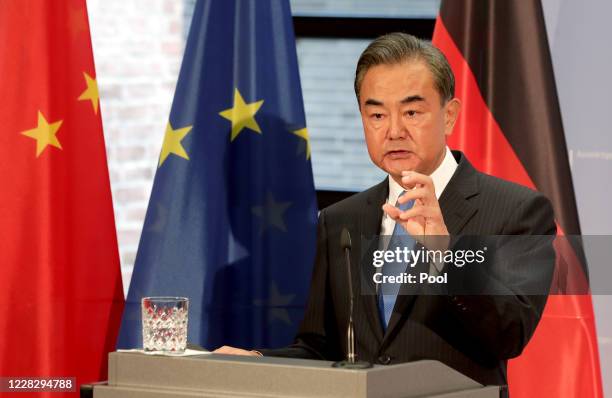 China's Foreign Minister Wang Yi addresses the media during a joint press conference with German Foreign Minister Heiko Maas as part of a meeting on...