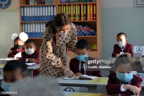 First grade students listen the instructor during a class as Kyrgyzstan government opens schools only for the 1st grade students, in Bishkek,...