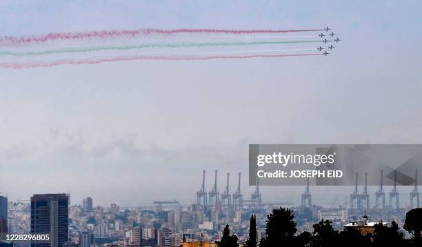 Alpha jets of the Patrouille de France release smoke in the colours of the Lebanese flag while flying over the scene of Beirut port explosion on...