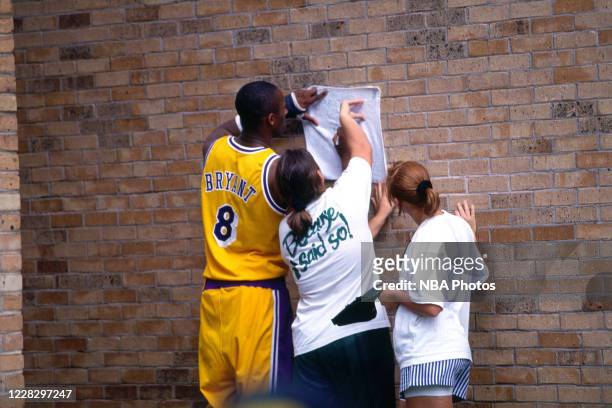 Kobe Bryant of the Los Angeles Lakers signs an autograph during the 1996 NBA Rookie Photo Shoot on September 20, 1996 in Orlando, Florida. NOTE TO...