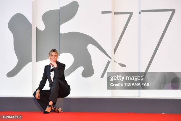 Master of Ceremonies and sponsor of the 77th Venice Film Festival, Italian actress Anna Foglietta poses during a photocall on the red carpet outside...