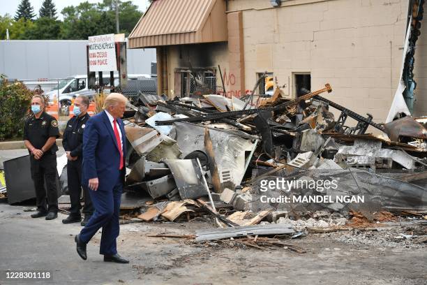 President Donald Trump tours an area affected by civil unrest in Kenosha, Wisconsin on September 1, 2020. - Trump visited Kenosha, the Wisconsin city...