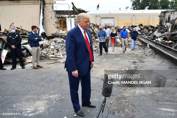 President Donald Trump speaks to the press as he tours an area affected by civil unrest in Kenosha, Wisconsin on September 1, 2020. - Trump visited...