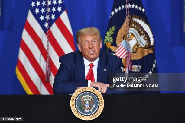 President Donald Trump speaks to officials during a roundtable discussion on community safety, at Mary D. Bradford High School in in Kenosha,...