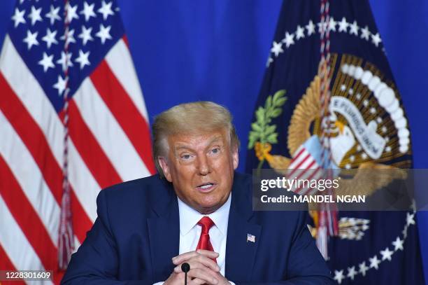 President Donald Trump speaks to officials during a roundtable discussion on community safety, at Mary D. Bradford High School in in Kenosha,...